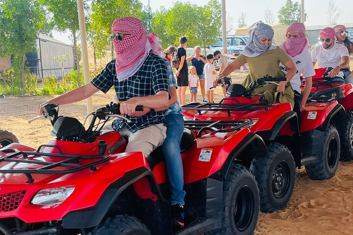 Experience the fun of exploring Dubai's desert terrain on a quad bike followed by a memorable evening filled with camel rides delicious BBQ and captivating dance performances.